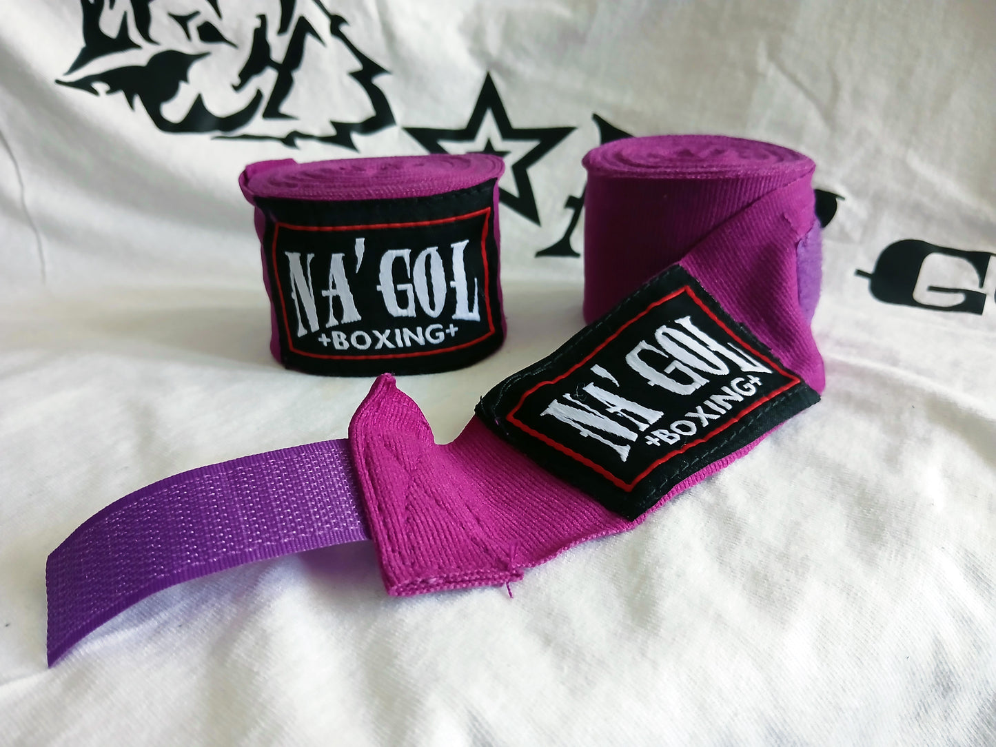 Purple boxing hand wraps with 'NA'GOL BOXING' branding on a white background