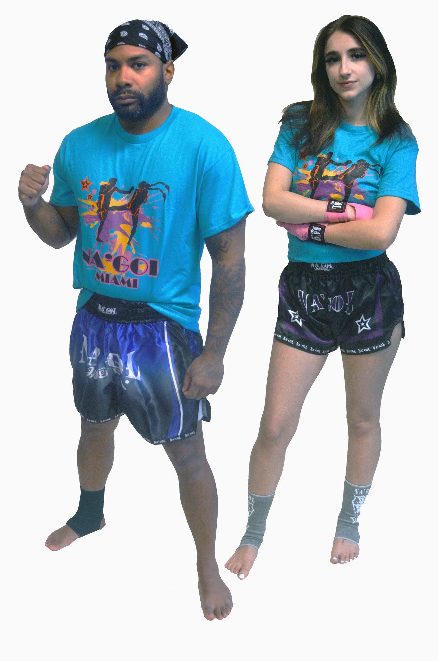Two people wearing matching blue t-shirts and black shorts with colorful designs on a white background.