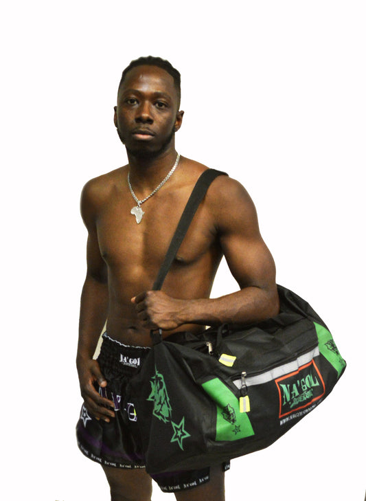 Man holding a black duffel bag with green accents on a white background