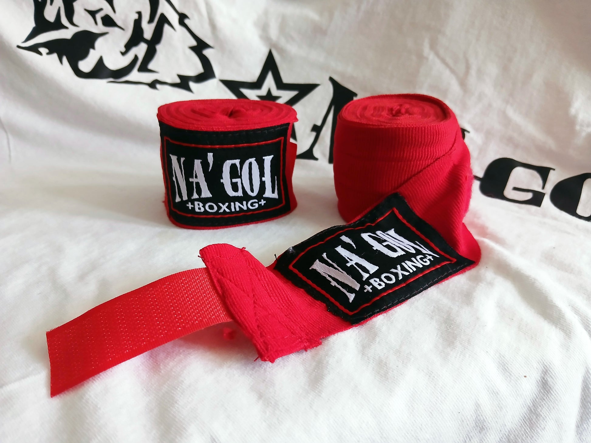 Red boxing hand wraps with NA'GOL branding on a white background